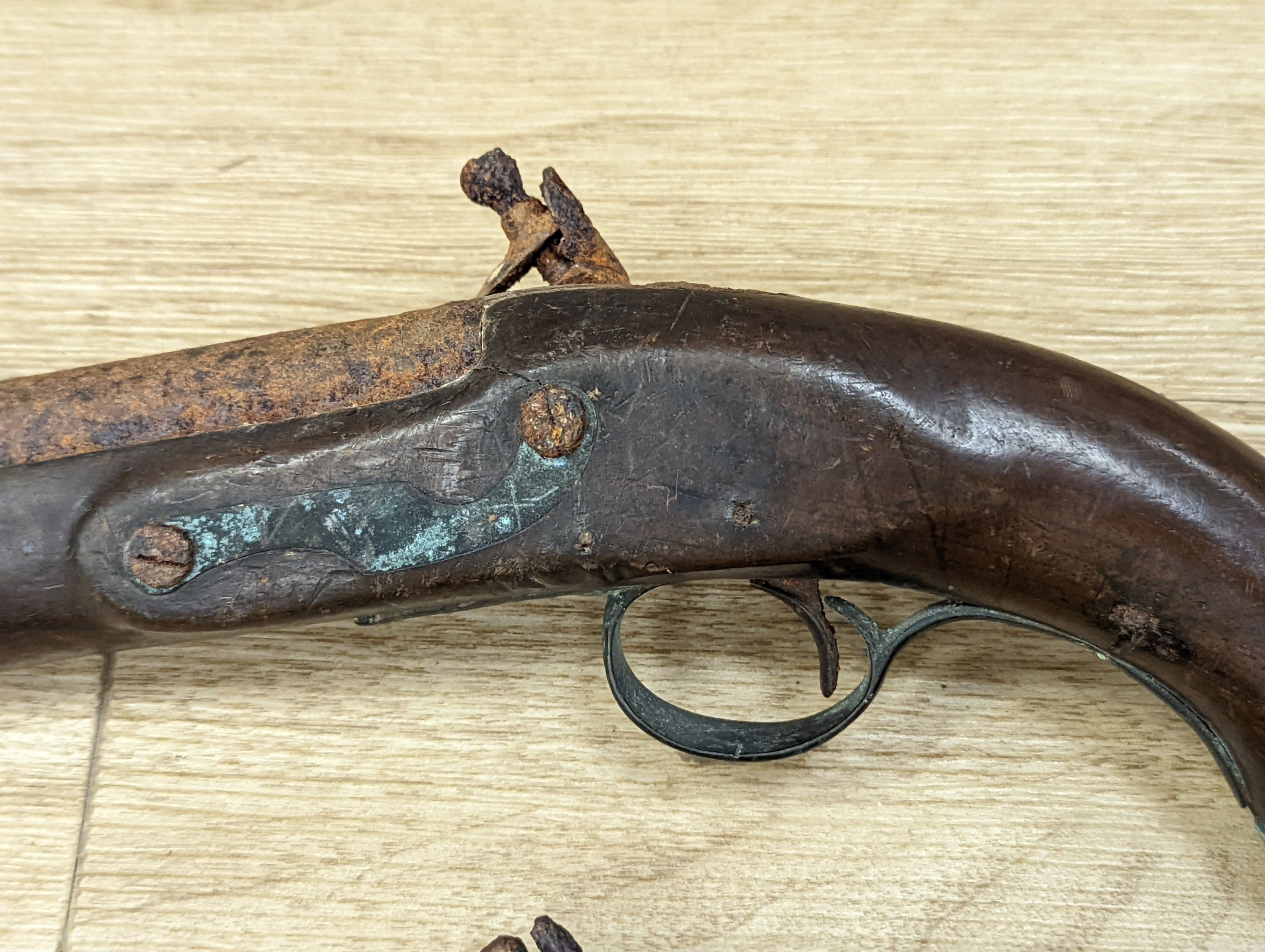 Two 19th century flintlock pistols and a pocket pistol, largest 40 cms long.